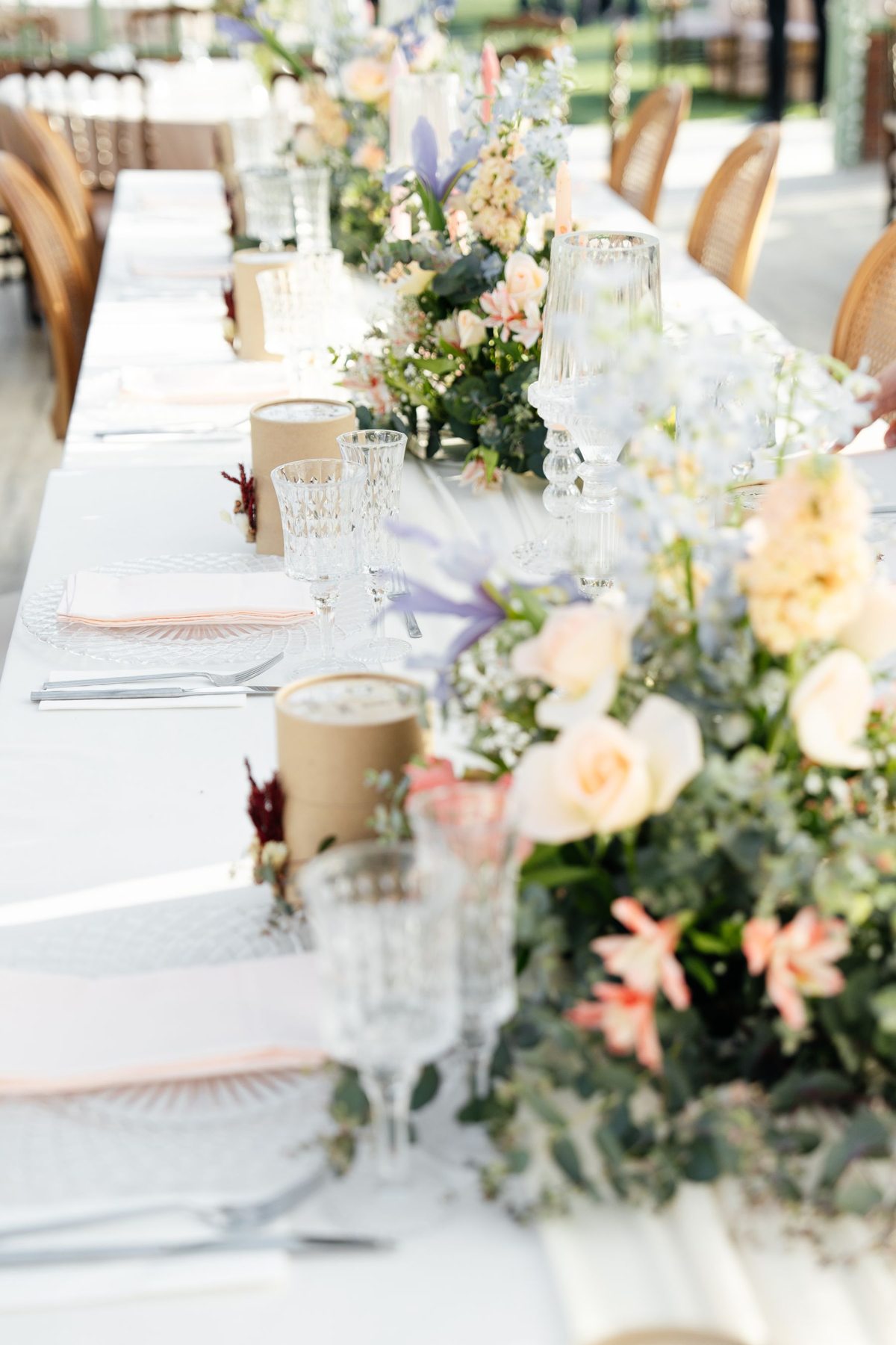 Pastel flowers and glassware on a wedding table